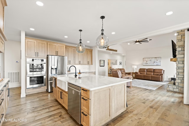 888 Smokey Quartz Blvd, New Tazewell, TN 37825 - kitchen featuring stainless steel appliances, light brown cabinets, a sink, light wood-style floors, and a ceiling fan