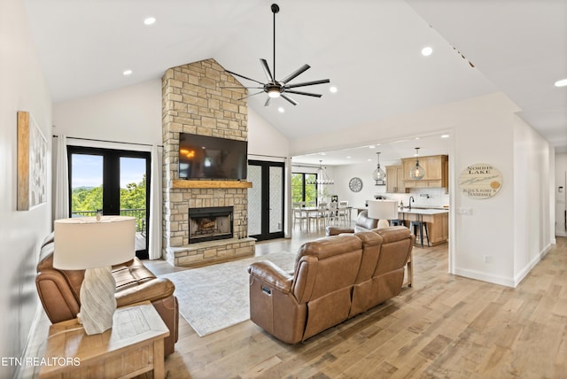 888 Smokey Quartz Blvd, New Tazewell, TN 37825 - living room with a ceiling fan, high vaulted ceiling, light wood-type flooring, a stone fireplace, and recessed lighting