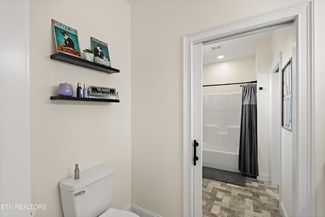 888 Smokey Quartz Blvd, New Tazewell, TN 37825 - bathroom featuring baseboards, toilet, shower / bath combo, and stone finish flooring