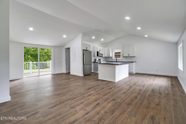 1095 Franklin Rd, Jamestown, TN 38556 - kitchen featuring stainless steel appliances, open floor plan, lofted ceiling, white cabinetry, and dark countertops