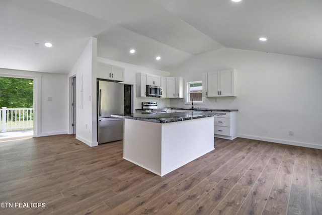 1095 Franklin Rd, Jamestown, TN 38556 - kitchen featuring stainless steel appliances, vaulted ceiling, white cabinetry, a kitchen island, and dark wood finished floors