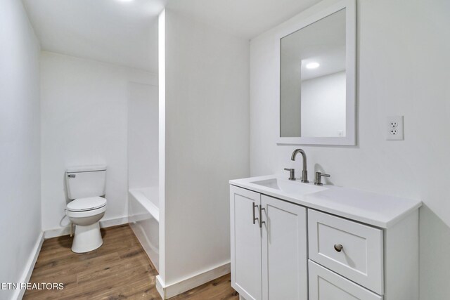 1095 Franklin Rd, Jamestown, TN 38556 - full bathroom featuring toilet, vanity, wood finished floors, and a bathtub
