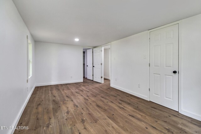 1095 Franklin Rd, Jamestown, TN 38556 - unfurnished bedroom featuring wood finished floors, baseboards, and recessed lighting