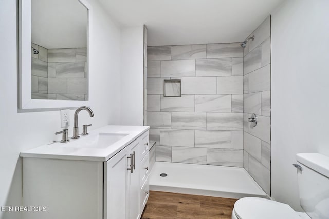 1095 Franklin Rd, Jamestown, TN 38556 - full bathroom with vanity, toilet, tiled shower, and wood finished floors