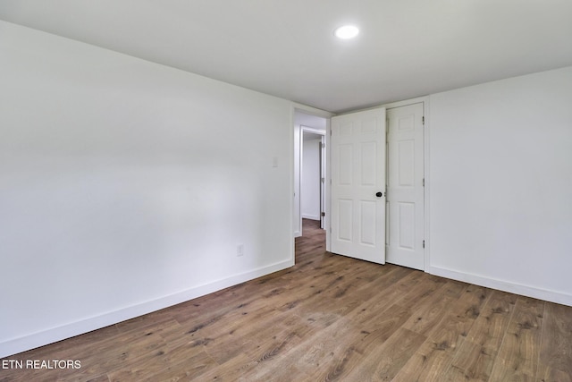 1095 Franklin Rd, Jamestown, TN 38556 - unfurnished bedroom with baseboards, wood finished floors, and recessed lighting