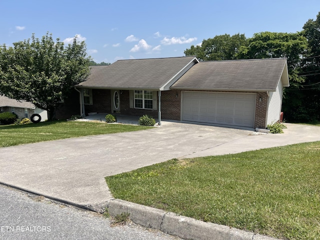 159 Emory Ln, Tazewell, TN 37879 - ranch-style house featuring driveway, a garage, a front lawn, covered porch, and brick siding