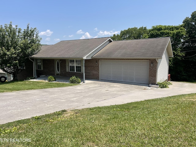 159 Emory Ln, Tazewell, TN 37879 - single story home with concrete driveway, a garage, a front lawn, brick siding, and covered porch
