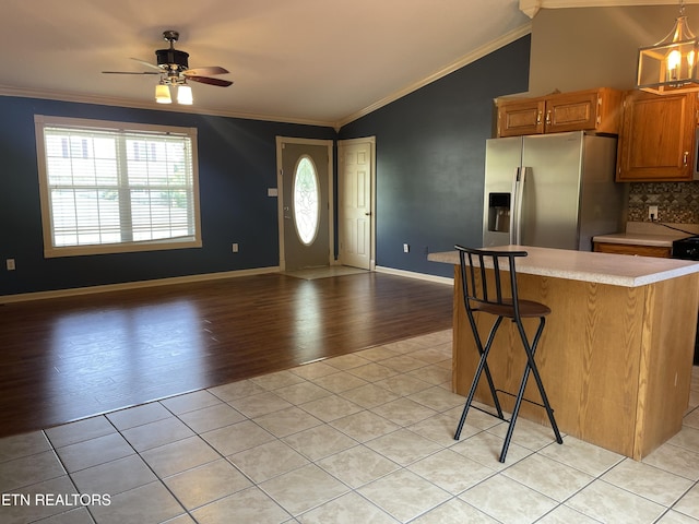 159 Emory Ln, Tazewell, TN 37879 - kitchen with stainless steel refrigerator with ice dispenser, light countertops, crown molding, light wood-style floors, and open floor plan