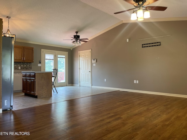 159 Emory Ln, Tazewell, TN 37879 - unfurnished living room featuring ceiling fan, crown molding, light wood-type flooring, vaulted ceiling, and a textured ceiling