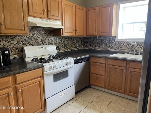 159 Emory Ln, Tazewell, TN 37879 - kitchen featuring white gas range oven, dishwasher, under cabinet range hood, a sink, and light tile patterned flooring