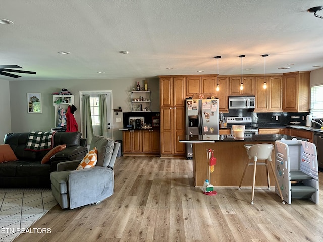 306 E Tri County Blvd, Oliver Springs, TN 37840 - kitchen with appliances with stainless steel finishes, open floor plan, brown cabinetry, light wood-type flooring, and recessed lighting