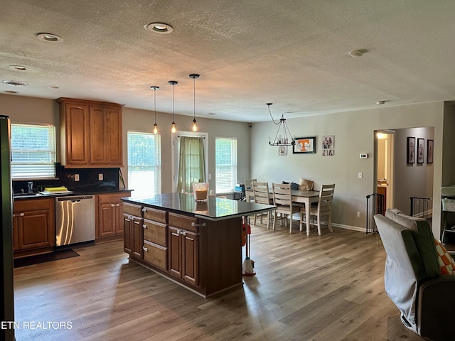 306 E Tri County Blvd, Oliver Springs, TN 37840 - kitchen with stainless steel dishwasher, a textured ceiling, dark countertops, plenty of natural light, and wood finished floors