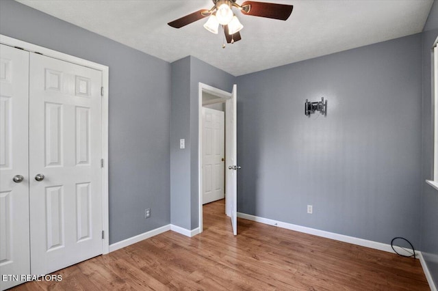 340 Mountain View Ests, Caryville, TN 37714 - unfurnished bedroom featuring baseboards, light wood-style floors, a closet, and a ceiling fan