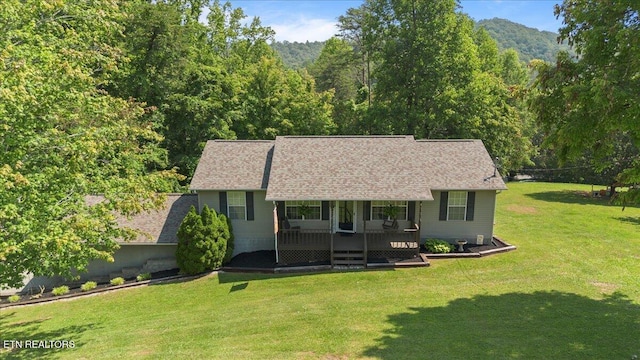 340 Mountain View Ests, Caryville, TN 37714 - view of front facade featuring a front lawn, a view of trees, roof with shingles, and covered porch