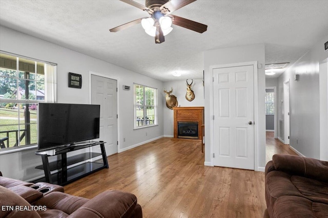 340 Mountain View Ests, Caryville, TN 37714 - living area with a textured ceiling, ceiling fan, healthy amount of natural light, and wood finished floors