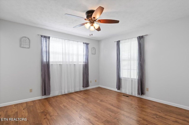 340 Mountain View Ests, Caryville, TN 37714 - unfurnished room featuring ceiling fan, wood finished floors, baseboards, and a textured ceiling