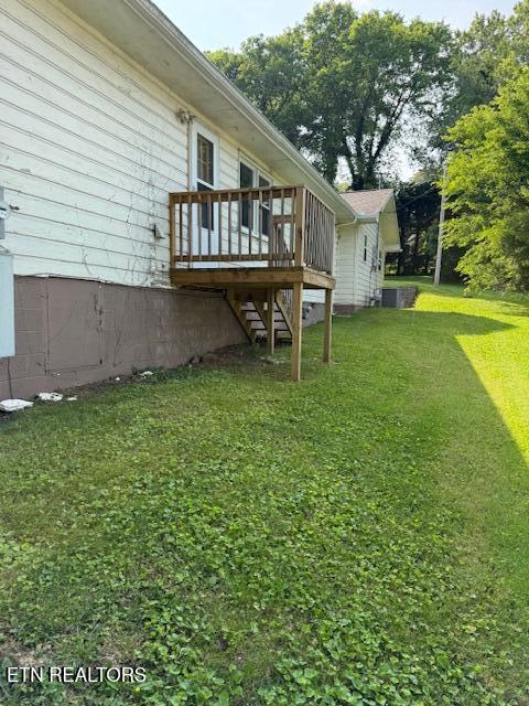 805 Sewanee St, Harriman, TN 37748 - view of green lawn featuring stairway, a wooden deck, and central AC unit