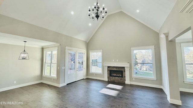 8017 Little Joe Rd, Powell, TN 37849 - unfurnished living room with plenty of natural light, dark wood-style flooring, a glass covered fireplace, high vaulted ceiling, and a chandelier