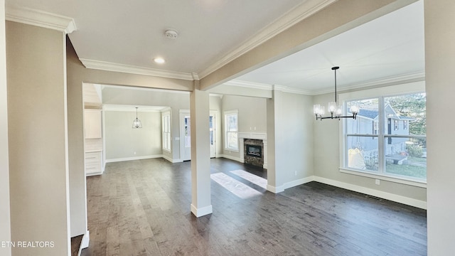 8017 Little Joe Rd, Powell, TN 37849 - unfurnished living room featuring a chandelier, baseboards, dark wood-type flooring, crown molding, and a fireplace