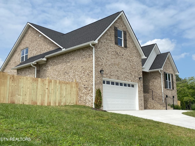 8017 Little Joe Rd, Powell, TN 37849 - view of home's exterior featuring concrete driveway, brick siding, and a garage