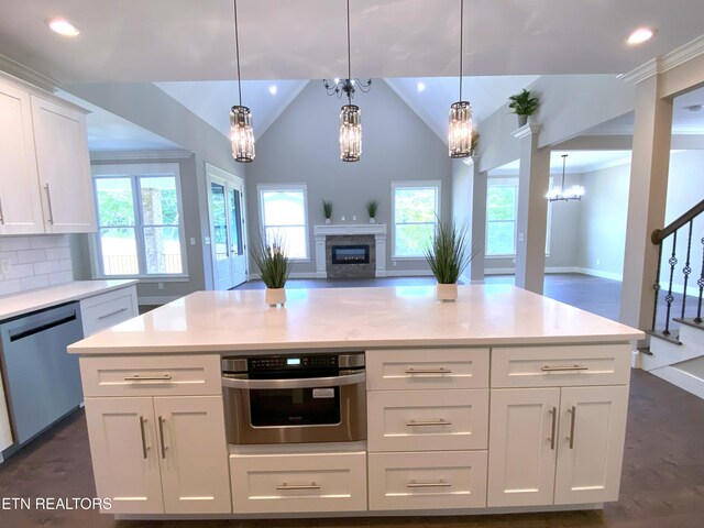 8017 Little Joe Rd, Powell, TN 37849 - kitchen featuring stainless steel appliances, a chandelier, a glass covered fireplace, healthy amount of natural light, and recessed lighting