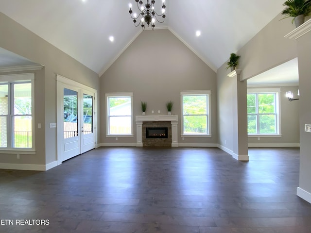 8017 Little Joe Rd, Powell, TN 37849 - unfurnished living room featuring a chandelier, a glass covered fireplace, dark wood-style floors, high vaulted ceiling, and baseboards