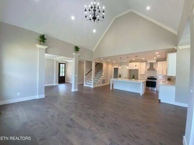 8017 Little Joe Rd, Powell, TN 37849 - unfurnished living room with stairway, dark wood-type flooring, baseboards, high vaulted ceiling, and crown molding
