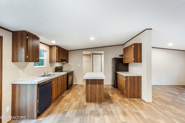 1527 Black Oak Dr, Sevierville, TN 37876 - kitchen with black appliances, light wood-type flooring, a sink, under cabinet range hood, and light countertops