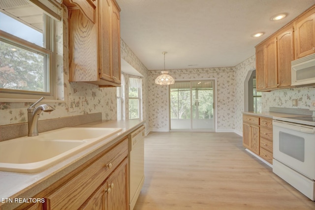 1023 Stokley Ct, Dandridge, TN 37725 - kitchen featuring white appliances, wallpapered walls, light wood finished floors, light countertops, and pendant lighting