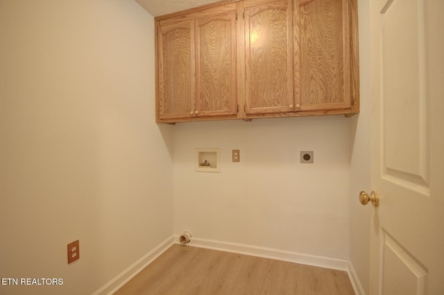 1023 Stokley Ct, Dandridge, TN 37725 - laundry room featuring washer hookup, light wood-type flooring, hookup for an electric dryer, and cabinet space