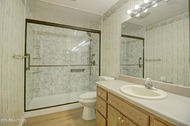 1023 Stokley Ct, Dandridge, TN 37725 - full bathroom with wallpapered walls, wood finished floors, vanity, and a marble finish shower
