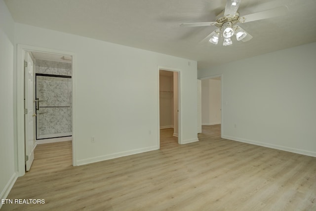 1023 Stokley Ct, Dandridge, TN 37725 - unfurnished bedroom featuring light wood-type flooring, a walk in closet, a closet, and a ceiling fan