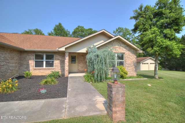 1023 Stokley Ct, Dandridge, TN 37725 - ranch-style house featuring brick siding, a front lawn, a garage, and roof with shingles