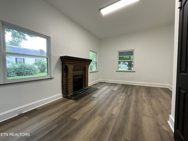 2634 Barton St, Knoxville, TN 37917 - unfurnished living room with dark wood-style floors, a brick fireplace, and baseboards