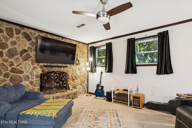 7901 Ewing Rd, Powell, TN 37849 - living room with carpet floors, a ceiling fan, a stone fireplace, and crown molding