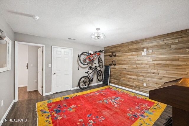 7901 Ewing Rd, Powell, TN 37849 - playroom with baseboards, wood finished floors, a chandelier, wood walls, and a textured ceiling