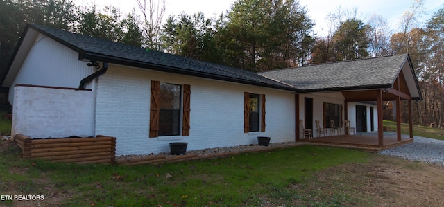 1497 Clevenger Rd, New Market, TN 37820 - back of house featuring brick siding, a patio area, a lawn, and roof with shingles