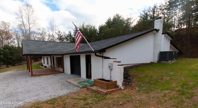 1497 Clevenger Rd, New Market, TN 37820 - view of front facade featuring a chimney, cooling unit, roof with shingles, and brick siding