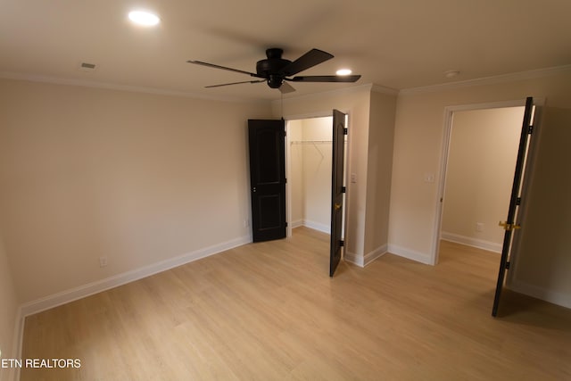 1497 Clevenger Rd, New Market, TN 37820 - unfurnished bedroom featuring ornamental molding, light wood-style floors, recessed lighting, a walk in closet, and baseboards