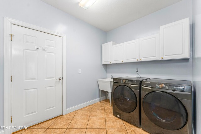 7924 Cedar Stone Ln, Powell, TN 37849 - washroom with cabinet space, separate washer and dryer, and light tile patterned floors