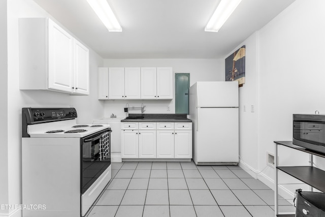 7924 Cedar Stone Ln, Powell, TN 37849 - kitchen with freestanding refrigerator, electric stove, white cabinetry, light tile patterned flooring, and dark countertops