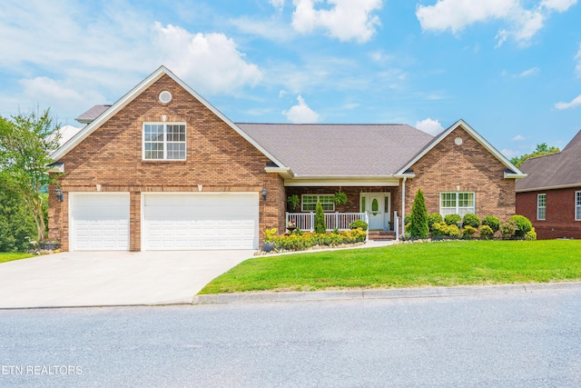 7924 Cedar Stone Ln, Powell, TN 37849 - traditional-style house featuring brick siding, covered porch, a front lawn, and driveway