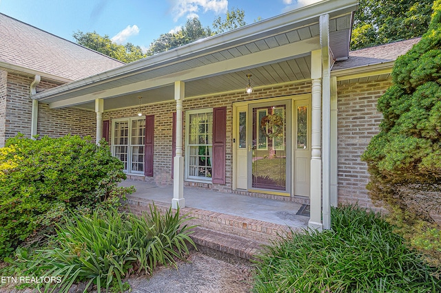 4512 Clairson Dr, Knoxville, TN 37931 - doorway to property featuring brick siding, covered porch, and a shingled roof
