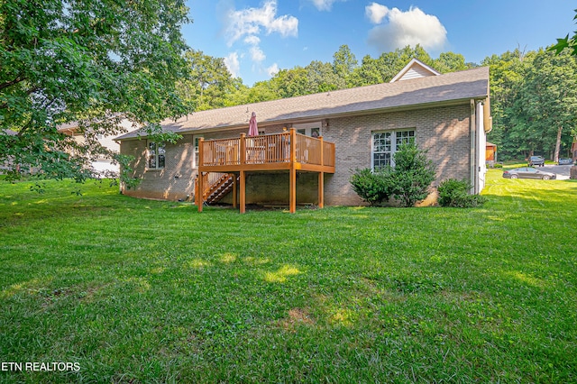 4512 Clairson Dr, Knoxville, TN 37931 - rear view of property featuring a deck, stairs, a yard, brick siding, and roof with shingles