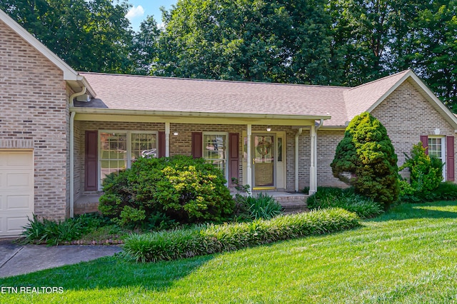 4512 Clairson Dr, Knoxville, TN 37931 - view of front facade featuring brick siding, a front lawn, and a shingled roof