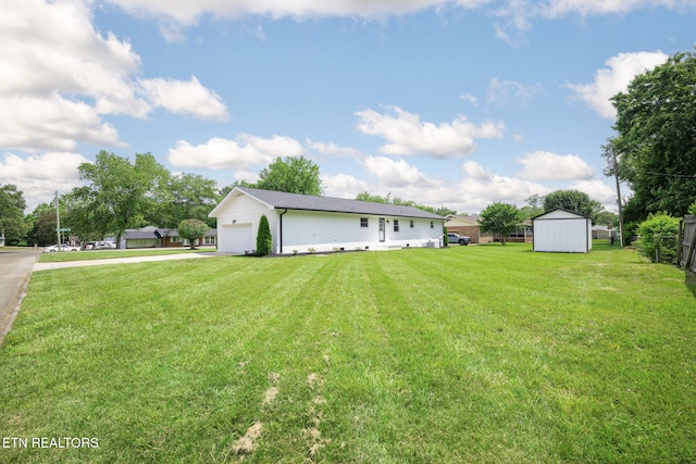 7339 Brookside Dr, Chattanooga, TN 37421 - view of front of home featuring a front yard, concrete driveway, a storage shed, and a garage