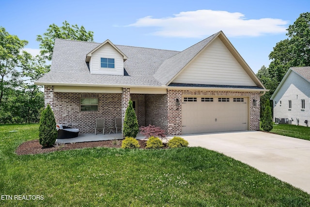 20 Cabot Ln, Cookeville, TN 38506 - view of front of house featuring brick siding, a garage, a front lawn, and driveway