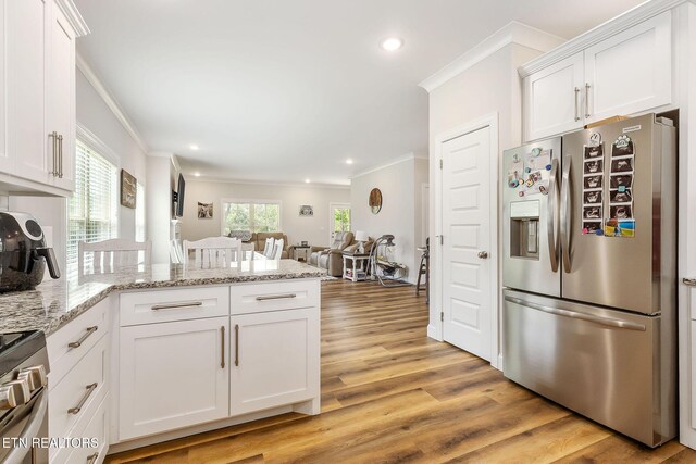 20 Cabot Ln, Cookeville, TN 38506 - kitchen with appliances with stainless steel finishes, ornamental molding, a peninsula, white cabinetry, and light wood finished floors
