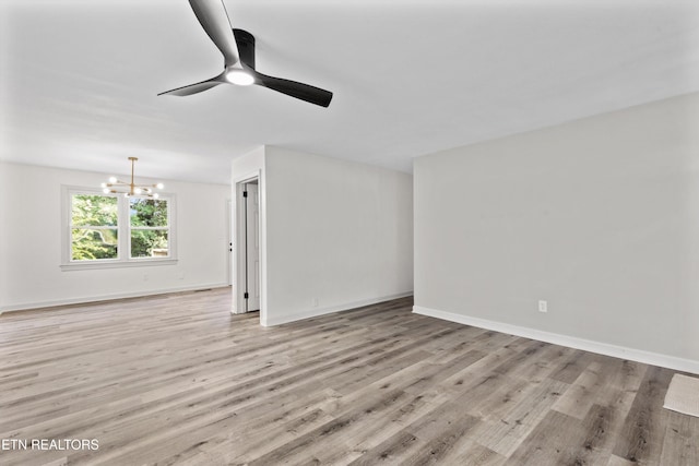 340 Gilbert St, Morristown, TN 37814 - unfurnished living room with a chandelier, light wood-type flooring, ceiling fan, and baseboards