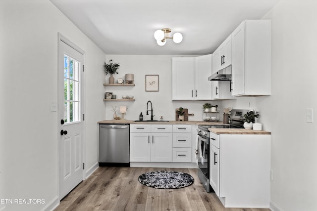 340 Gilbert St, Morristown, TN 37814 - kitchen with stainless steel appliances, under cabinet range hood, a sink, light wood-style floors, and white cabinets